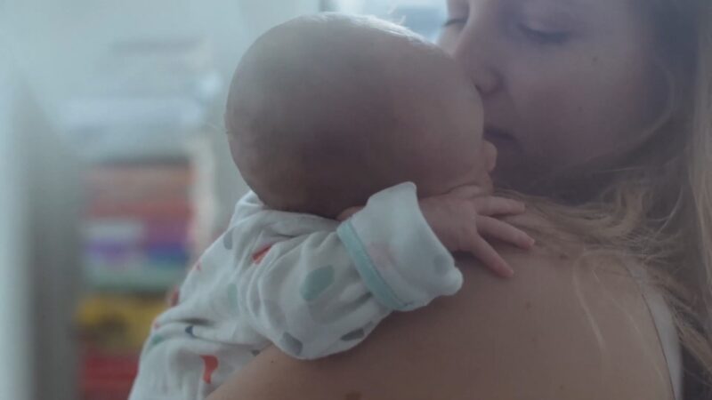 A Mother Holds Her Newborn Baby