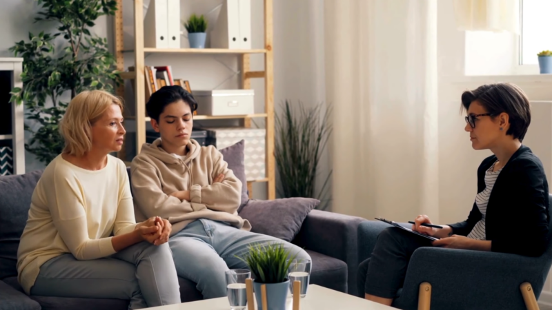 A Therapist Conducting a Counseling Session with A Mother and Her Teenage Child