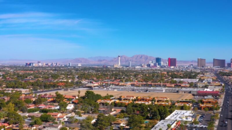 Aerial View of Las Vegas Showcasing Residential Areas and The Distant Strip Against a Backdrop of Mountains