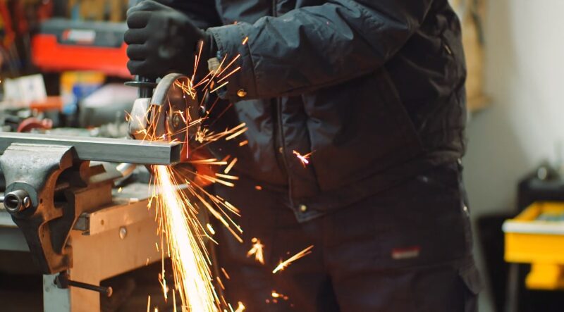 A Worker Uses a Grinder, Creating Sparks in A Workshop in St. Louis