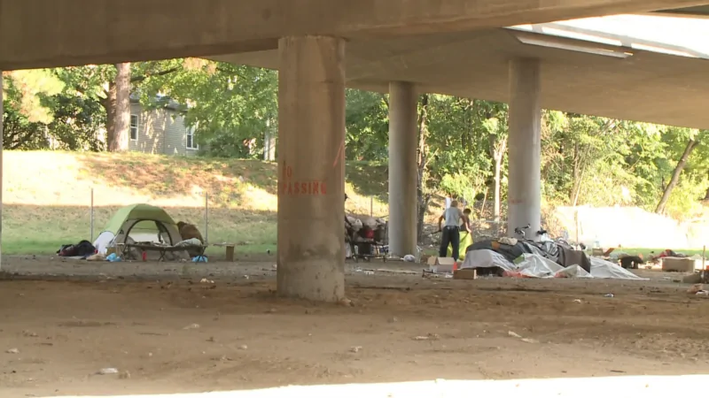 A Homeless Encampment with Tents and Belongings Is Set up Under a Bridge in St. Louis