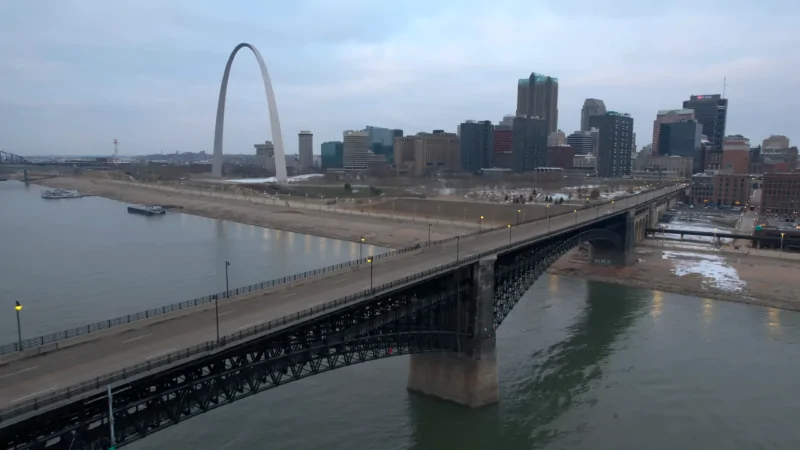 The Image Shows the St. Louis Arch, a Bridge, and The City Skyline Across the River