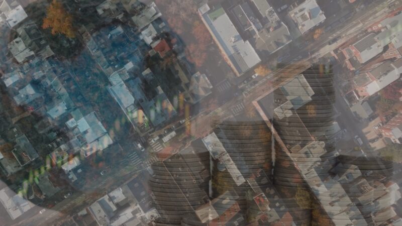 An Aerial View of A Residential Neighborhood in Philadelphia Overlaid with Transparent Images of Stacked Coins and A Fluctuating Stock Market Graph, Symbolizing the Economic Impacts of Population Changes in The City