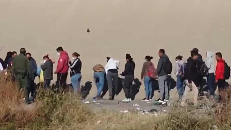 A Group of People Standing in Line Outdoors, Symbolizing the Process of Immigration in Philadelphia