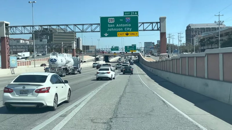 Traffic on A Busy San Antonio Freeway with Directional Signs to Johnson City and Downtown