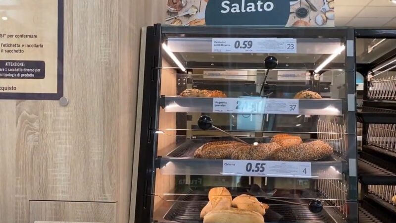 A Self-Service Bakery Display in A Store, Showing Various Types of Bread with Price Tags in Euros