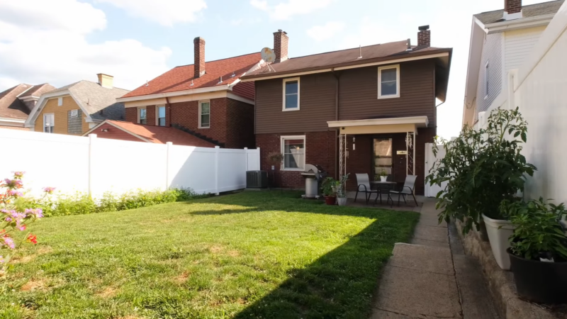 Backyard View of A Pittsburgh Home with A Lawn and Patio Area