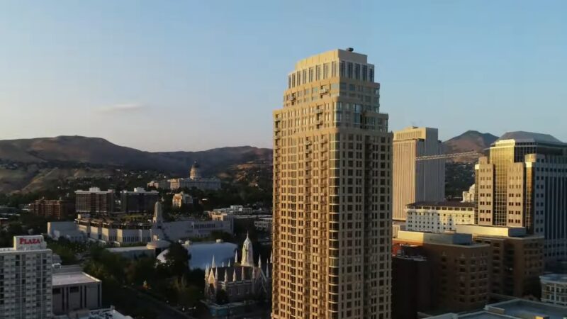 A Cityscape in Utah with Tall Buildings and The State Capitol in The Background, Highlighting Urban Development and Its Economic Impact Amid Population Changes