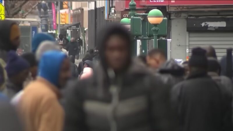 The Image Shows a Busy City Street with A Crowd of People Walking, Possibly Representing the Internal Migration and Movement of Residents Within New York City