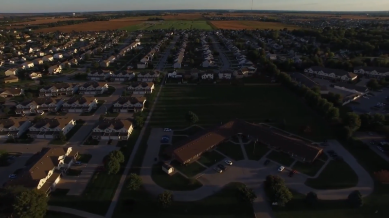 Aerial View of A Residential Suburb in Iowa During Sunset, Illustrating the Expansive Housing Developments Characteristic of The State's Real Estate Trends