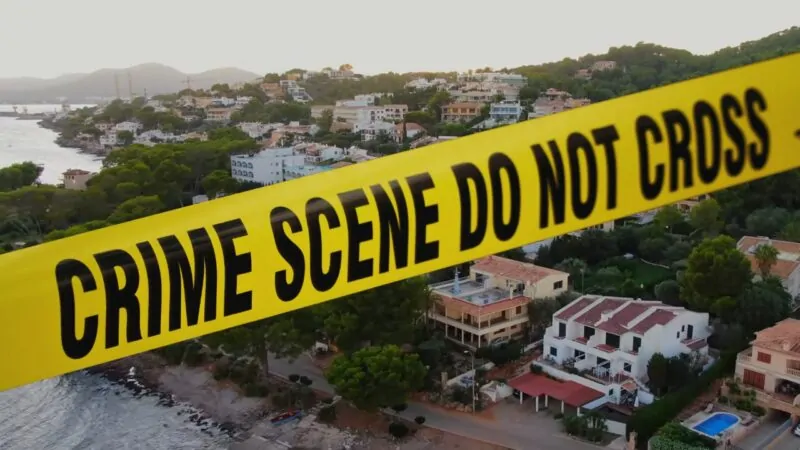 A Yellow "Crime Scene Do Not Cross" Tape Is Placed in Front of A Coastal Neighborhood in Mallorca, Suggesting a Safety or Crime-Related Issue in The Area