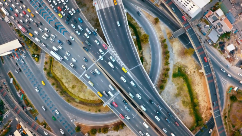 Aerial Shot of A Busy Highway Interchange with Dense Traffic, Illustrating Heavy Urban Congestion in Los Angeles