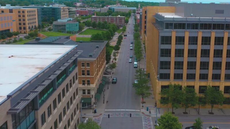 Aerial View of A University Town in Iowa with Modern Buildings and Tree-Lined Streets, Highlighting Urban Development Influenced by Migration Trends