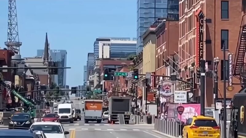 A Bustling Street in Downtown Nashville Filled with Cars, Trucks, and Pedestrians, Symbolizing the City's Rapid Population Growth and Urban Expansion