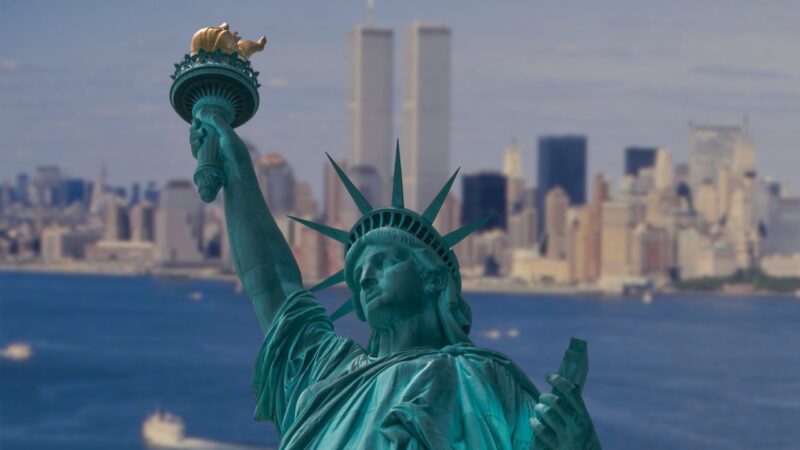 The Image Shows the Statue of Liberty in The Foreground with The Skyline of New York City, Including the Twin Towers, in The Background, Representing a Historical View of The City