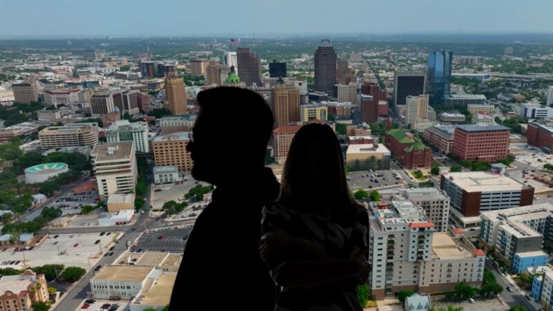 Silhouetted Couple Overlooking the Bustling Cityscape of San Antonio, Illustrating the San Antonio Population Growth