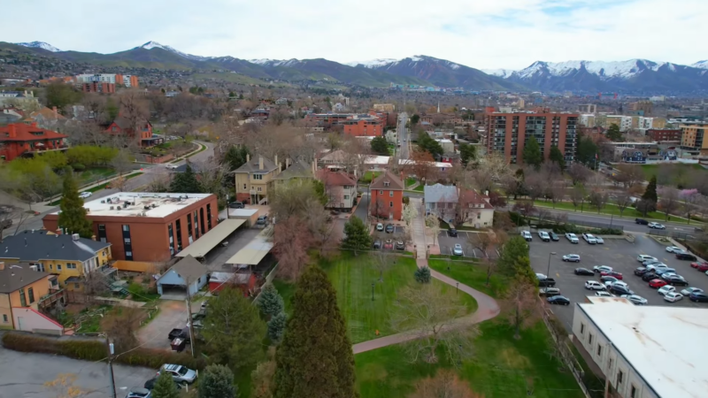 Aerial View of A Utah Neighborhood with A Mix of Residential Buildings, Green Spaces, and Distant Mountains, Reflecting the State's Evolving Demographic Landscape and Urban Growth