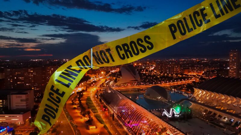 Police Tape Over a Nighttime View of Valencia, Spain, Highlighting Concerns About the Crime Rate in 2024