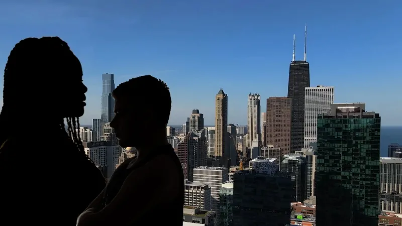 Silhouettes of Two People Against the Backdrop of Chicago's Skyline, Representing a Snapshot of The City's Vibrant and Diverse Population in 2024