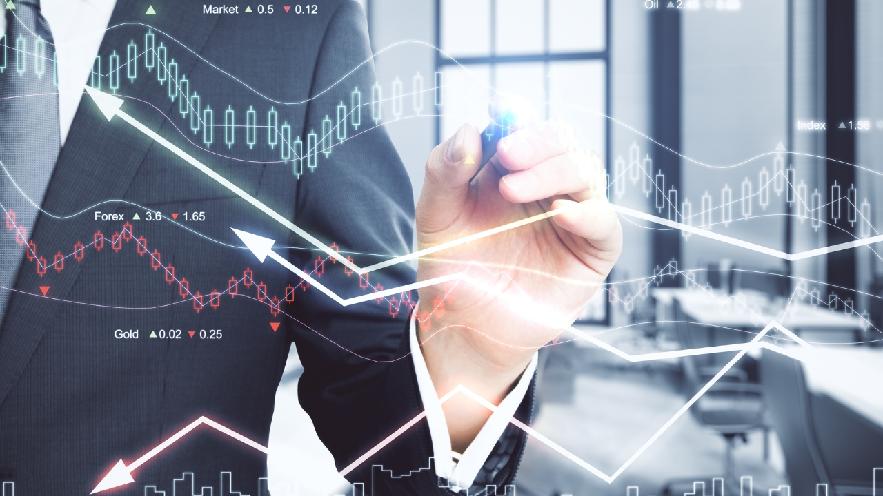 Businessperson points at digital market charts over an office background