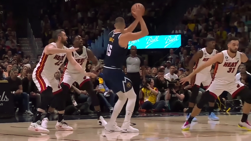 Nikola Jokic of The Denver Nuggets Holds the Ball During an NBA Playoff Game Against the Miami Heat