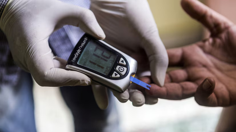 A Healthcare Worker Uses a Blood Glucose Meter to Check the Blood Sugar Levels of A Person with Type 1 Diabetes