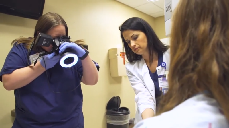 A Forensic Nurse Assists in Documenting Evidence While Another Healthcare Professional Takes a Photograph