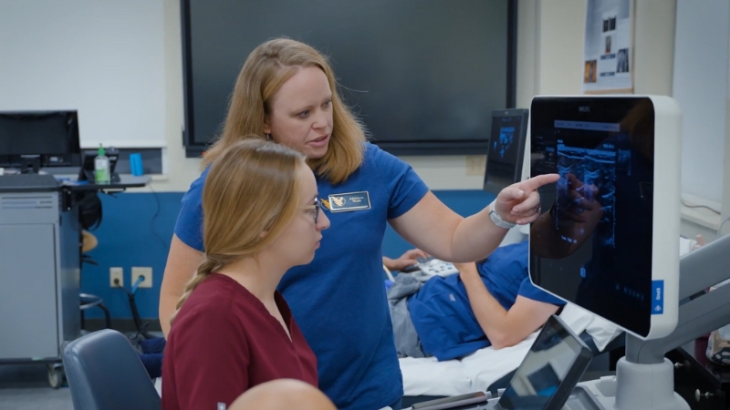 A Healthcare Instructor Demonstrates Ultrasound Techniques to A Student in A Wyoming Medical Training Facility