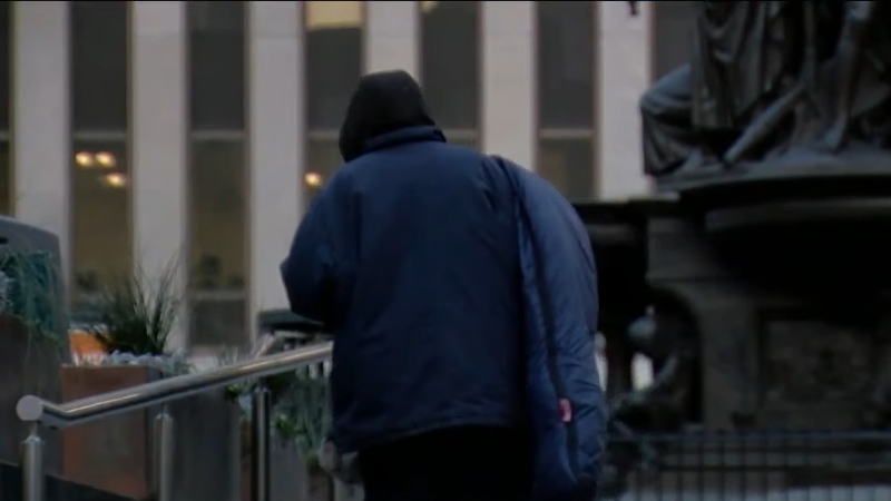 A Homeless Person Walks Through a City Area in Washington D.C.