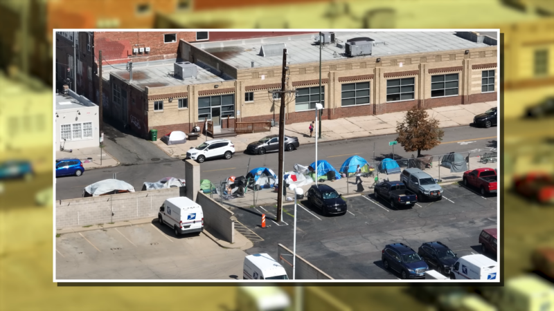 A Row of Tents Set up By Homeless Individuals Along a Street in Denver