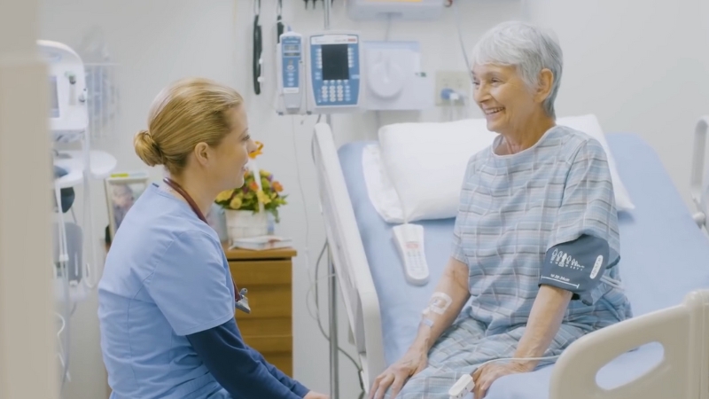 A Nurse Checks on A Patient, Showing Real-World Clinical Experience from An ABSN Program