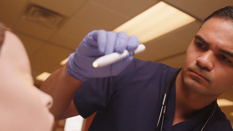 A Nursing Student Practices a Clinical Skill