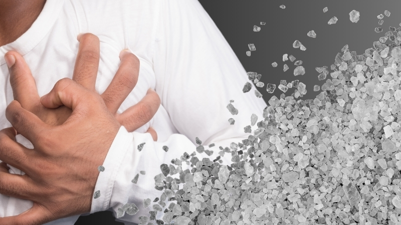 A Person Holding Their Chest, with Salt Crystals, Showing how Too Much Salt Can Affect Heart Health