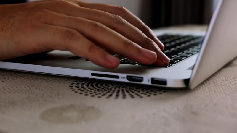 Close-Up of Hands Typing on A Laptop Keyboard, Representing the Role of Online Nursing Programs in Enhancing Career Advancement Opportunities