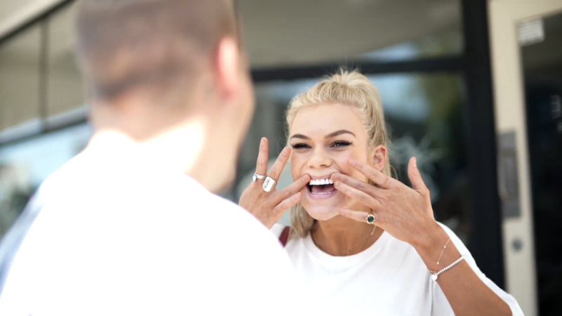 A Woman Happily Shows Off Her Newly Completed Dental Veneers