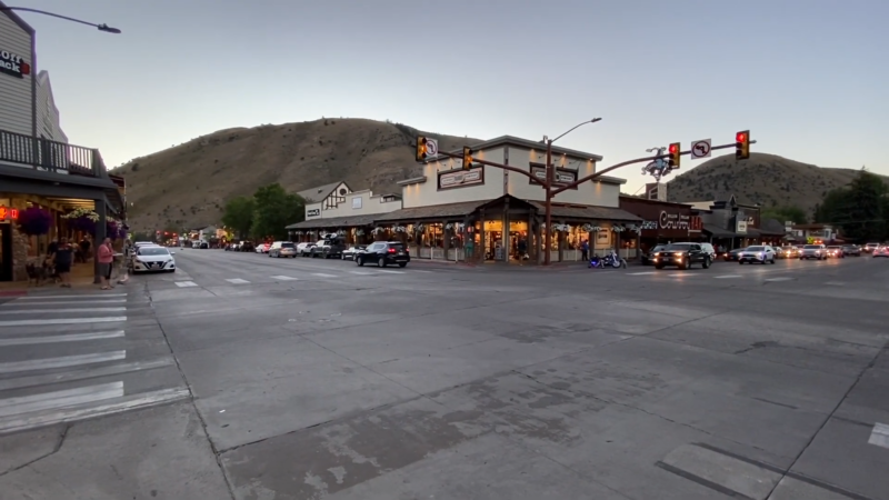 Downtown Jackson Hole, Wyoming, Showing a Bustling Street Scene Against the Backdrop of Hilly Terrain