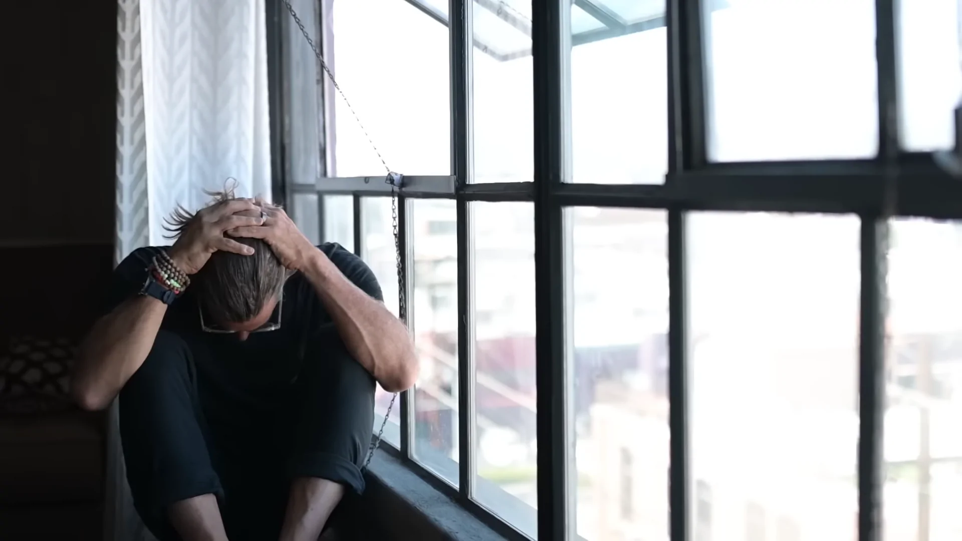 A Person Sitting by A Window, Reflecting on Recovery, Related to California's Rehabilitation Success Rates