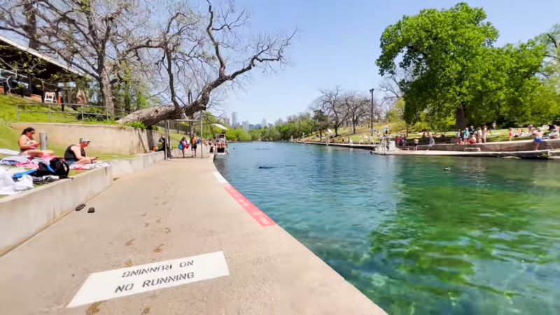 Barton Springs Pool in Austin, Texas, with People Relaxing by The Water