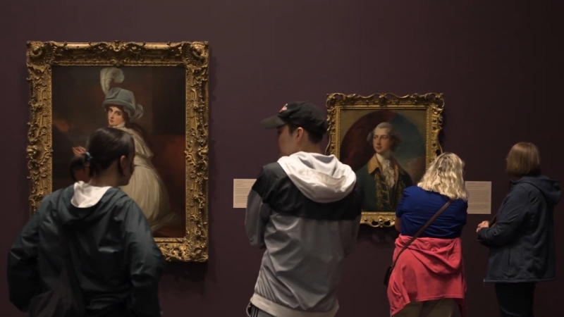 Visitors Observing Portrait Paintings at The Blanton Museum of Art in Austin, Texas