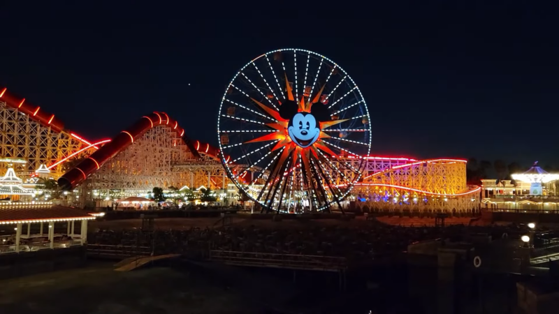 Night View of The Illuminated Mickey Mouse Ferris Wheel and Roller Coaster at Disneyland in Los Angeles