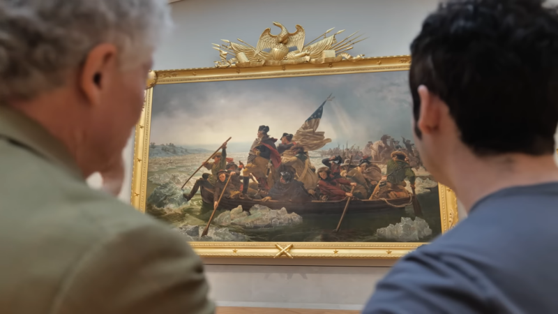 Two Visitors Viewing the Iconic Painting "Washington Crossing the Delaware" at The Metropolitan Museum of Art in New York City