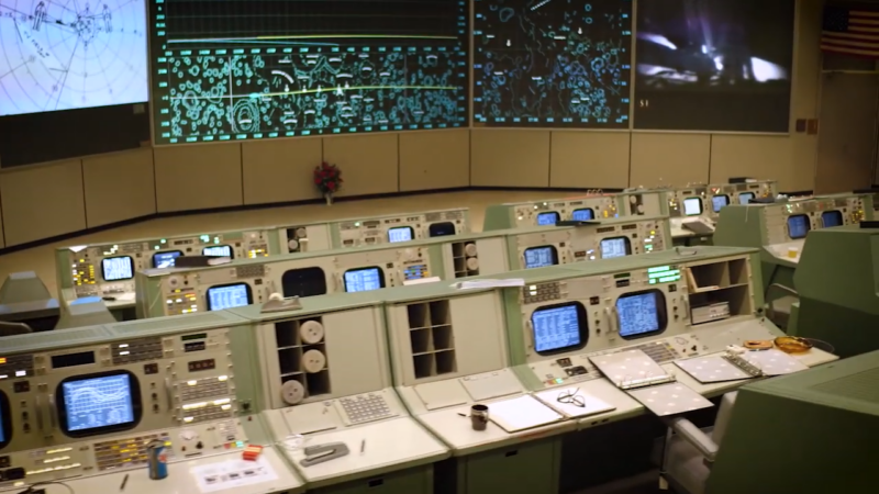 The Mission Control Center at Johnson Space Center with Workstations and Screens Showing Space Data