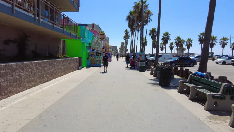 Venice Beach Boardwalk with Shops, Palm Trees, and People Walking