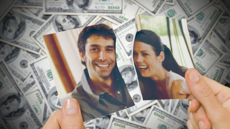 Two People Holding Torn Photos of Themselves Over a Background of Money