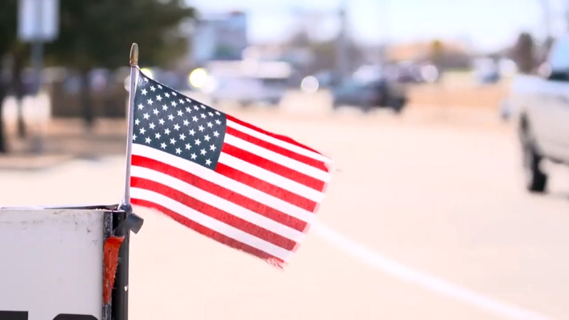 A Close-Up of An American Flag Fluttering in The Wind on A Street in North Texas