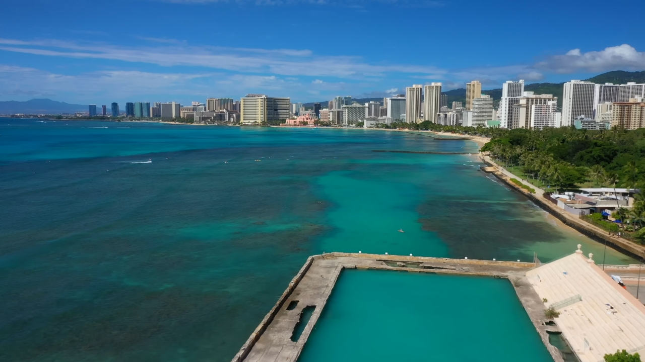 Honolulu skyline beside turquoise water and Waikiki Beach