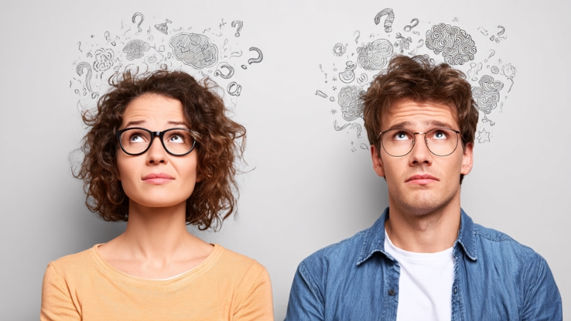 Man and woman look up with symbols above their heads about IQ measurement
