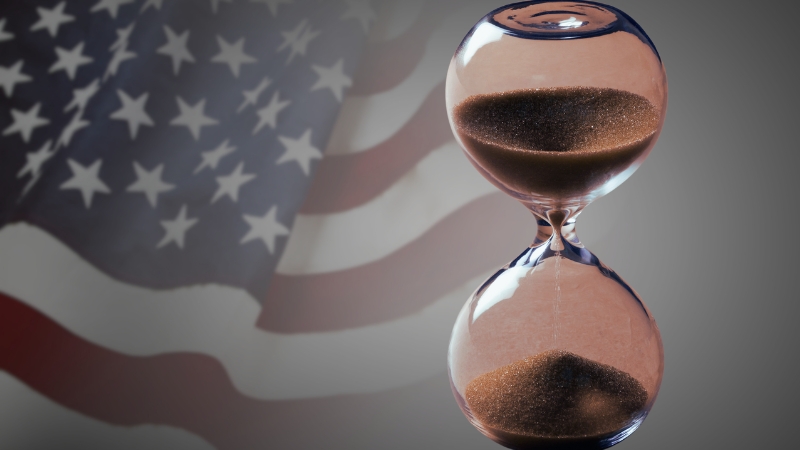 An Hourglass in Front of The U.S. Flag