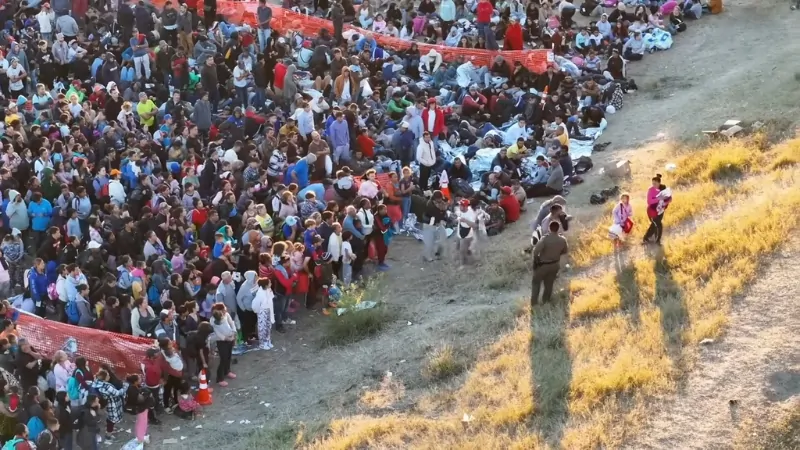 A Large Crowd of People Gathered Near a Border Area, Highlighting Issues Related to Unauthorized Immigration and US Border Crossings