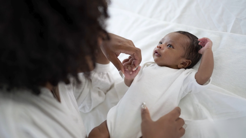 A Mother Gently Interacting with Her Newborn Baby, Emphasizing the Significance of Birth Injury Awareness in The U.S.